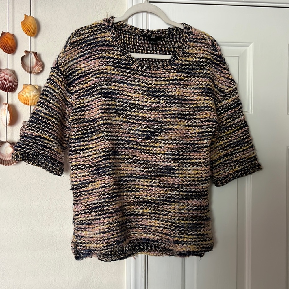 A multi colored short fuzzy sweater. Good condition.
